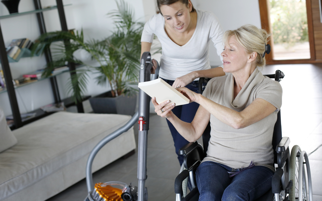 Disabled woman showing female caregiver papers