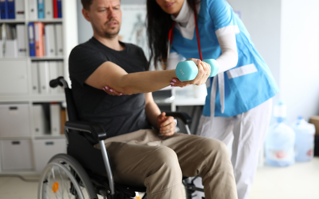 Female caregiver helps man through physical therapy session