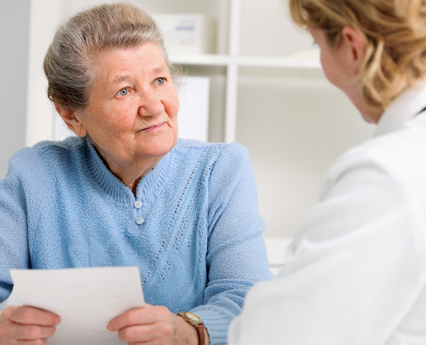 Female speech therapist leading an older woman through her session