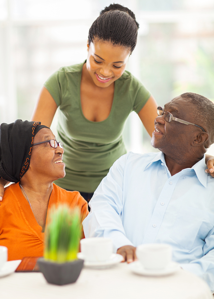 Young woman speaking with an older couple