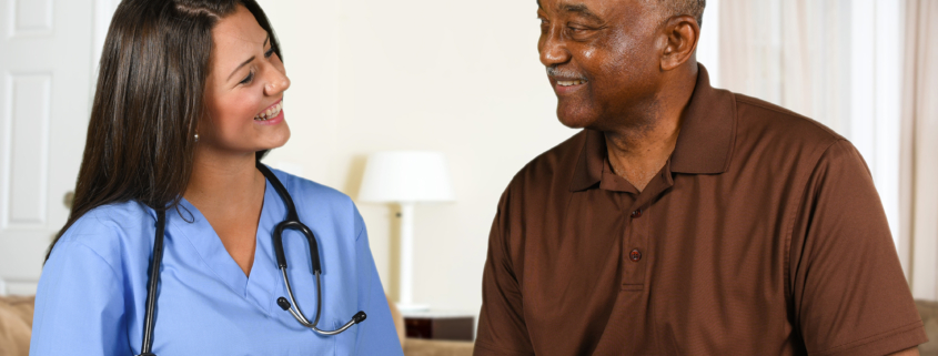 Female caregiver reading a book with an older man