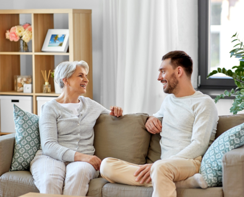 A young man teaching an older adult about the benefits of respite care