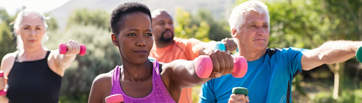 Woman in purple tank top leading a group in exercise