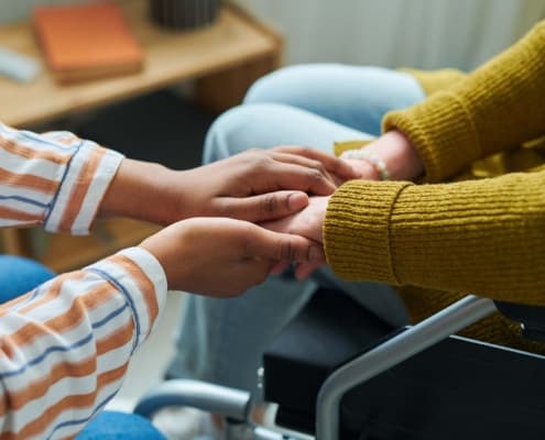 Care giver holding hands