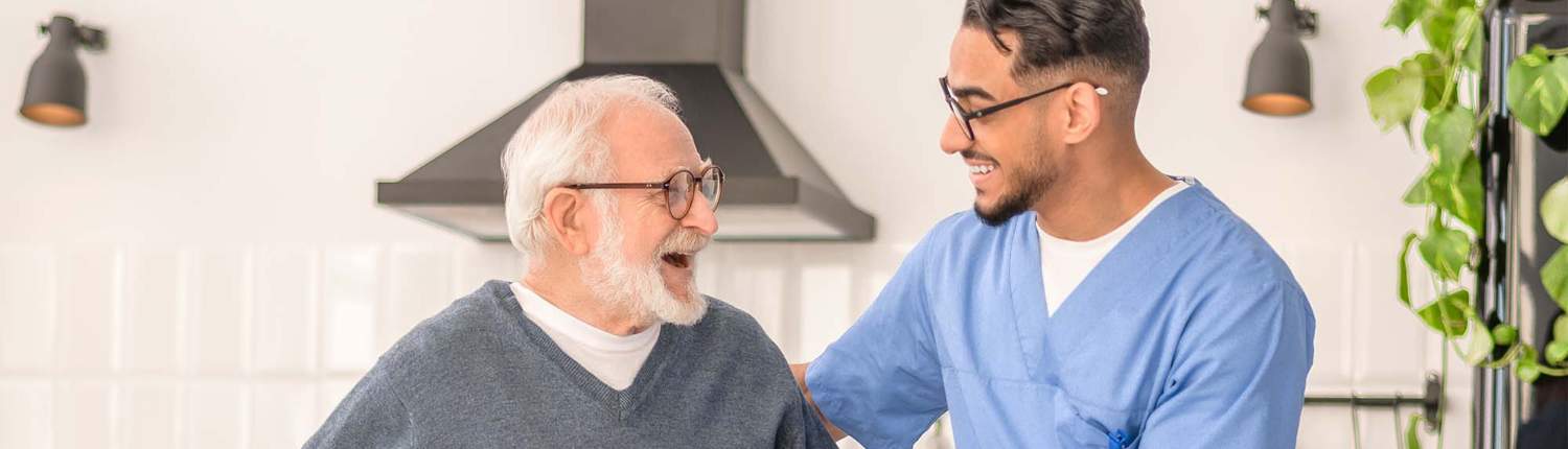 Patient moving around the kitchen assisted by his in-home nurse